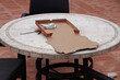 Empty pizza box and flatware left on an outdoor table after the meal