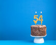 Birthday celebration with candle 54 - Chocolate cake on blue background