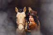 Portrait of a young woman and her palomino horse cosplay dressed in a steampunk outfit