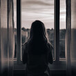 © Imagine Fx - Brown color black and white scene with The girl is seen from behind looking out the window,in evening time