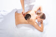 © Acronym - Young woman getting massaging treatment over white. Spa, healthcare and recreation concept.