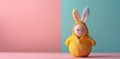 An egg with a yellow jacket with colorful bunny ears on a pastel background in a minimalist concept, Easter celebration concept.
