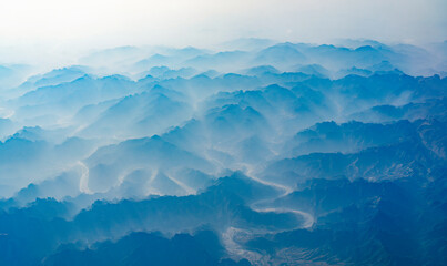 Wall Mural - aerial view of mountain range in fog
