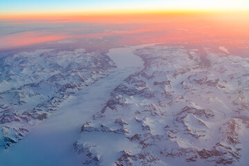 Wall Mural - aerial view of snow mountain and frozen river in colorful morning sunlight in alaska