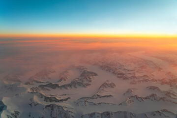 Wall Mural - aerial view of snow mountain and frozen river in colorful morning sunlight in alaska