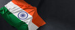 Flag of India. Fabric textured India flag isolated on dark background. 3D illustration