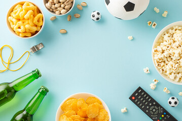 Euro 2024 snack scene: Assorted goodies for soccer fans! From chips to popcorn, crisps to pistachios, ice-cold beer and more. Top view on a pastel blue backdrop, perfect for ads or messages