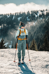 Mountaineer backcountry ski walking ski alpinist in the mountains. Ski touring in alpine landscape with snowy trees. Adventure winter sport. Low Tatras, slovakia