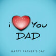 Happy Father's Day Greeting Card with I Love You Dad Text, Red Heart on Blue Background.