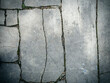 Stone pavement. Texture of stone paved ground. Large jagged stone blocks on a pedestrian sidewalk or road. Ancient masonry. Great for background and design.