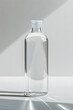 Glass bottle with water on white background