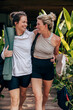 © Maskot - Happy female friends walking with arms around at wellness resort