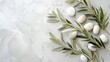 An aesthetically pleasing photo of an olive branch surrounded by white stones