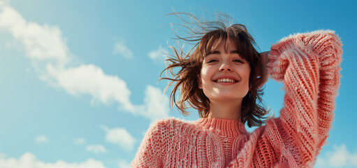 Portrait of a smiling woman standing against a blue sky