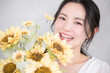Cute woman with sunflower bouquet Close-up of a cute image for bridal, beauty or pre-shoots Looking at the camera