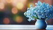 Blue flowers of a forget-me-not in a blue vase on a table. Blurred background