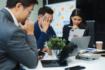 business people, teamwork, people and crisis concept - business team sitting sad and solving problem