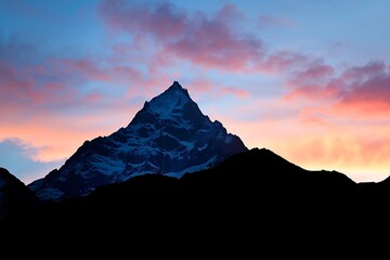 Wall Mural - The stark outline of a mountain peak at sunrise
