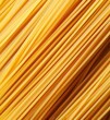 Heap of uncooked whole wheat spaghetti italian pasta, top view.