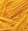 Heap of uncooked whole wheat spaghetti italian pasta, top view.