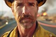 This image captures the intense gaze of a firefighter in close-up. His face shows signs of fatigue and resolve, set against a blurred background of an active fire scene.