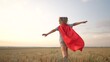 © maxximmm - kid superhero run. girl daughter happy family a dream concept. baby girl superhero run in red cape at sunset. portrait child superhero in the park. strength fantasy lifestyle concept