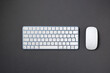 © yalcinsonat - Top view of wireless keyboard and mouse on dark gray work desk