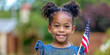 © evgeniia_1010 - A charming dark-skinned little girl joyfully holds an American flag in her hands. United States Independence Day, which is celebrated on July 4th. The presidential election is on November 5th.