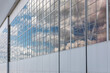 Aerial Background: Airplane Hangar with Reflective Glass under Blue Sky and Clouds