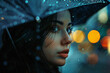 Portrait of a beautiful woman looking sideways under an umbrella on a rainy day