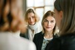 © senyumanmu - Female professional discussing with coworkers in meeting at conference event