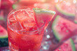 summer watermelon cocktail in a glass on a tropical background