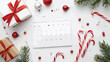 Blank paper calendar gift box and candy cane on white background 