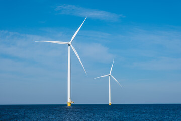 Wall Mural - Three colossal wind turbines stand tall and majestic in the vast expanse of the ocean, harnessing the powerful energy of the wind to generate electricity