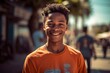 © MediaRaw - A young man wearing an orange shirt is smiling and posing for a picture