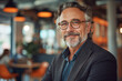 © ArtCraft - Confident mature businessman in a caf?. Portrays professionalism and success, ideal for corporate branding and editorial use