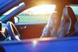 girl sitting in a car at sunset time, concept travel and business trip