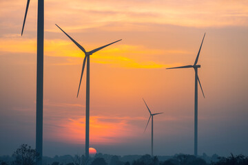 Wall Mural - electric wind turbine and the sun in the morning.wind energy, electricity production plant. high vol