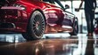© sorin - Professional detailer cleans red performance car with high pressure water at auto shop