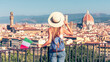 Woman tourist with bag, summer hat and italian flag in Italy- Florence