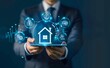 © Stocks Buddy - A businessman holding tablet with real estate and house icons on a virtual screen