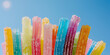 Close up view of gummy sweets with sugar on blue background Gummy Worm Candy in a Pile at a Market.
