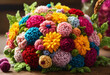Beautiful vivid colorful knitted dahlias and aster flowers made yarn on wooden desk. Wool floral decoration.