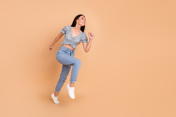 Sticker - Photo of funny nice woman woman wear blue stylish clothes run look empty space isolated on beige color background