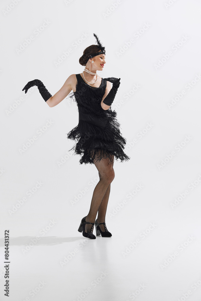 Beautiful young woman in vintage 1920s flapper dress, complete with ...