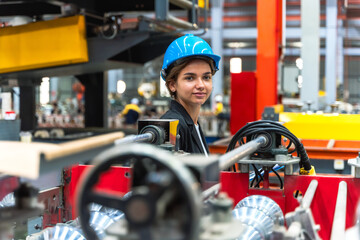 Young factory engineer woman working in metal sheet manufacturing industry 