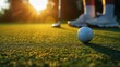 Playing golf, a man hits a ball with a club on the lawn in close-up