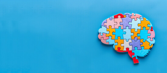 Human brain made up of colorful jigsaw puzzle isolated on wide blue background with space for text, Concept of  Autism, alzheimer awareness, seizure disorder