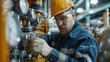 © komgritch - Engineer checking the pressure gauges on a pipeline in an industrial setting