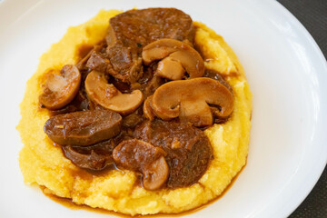 Traditional beef tongue in Madeira sauce with polenta. Brazilian rustic dish